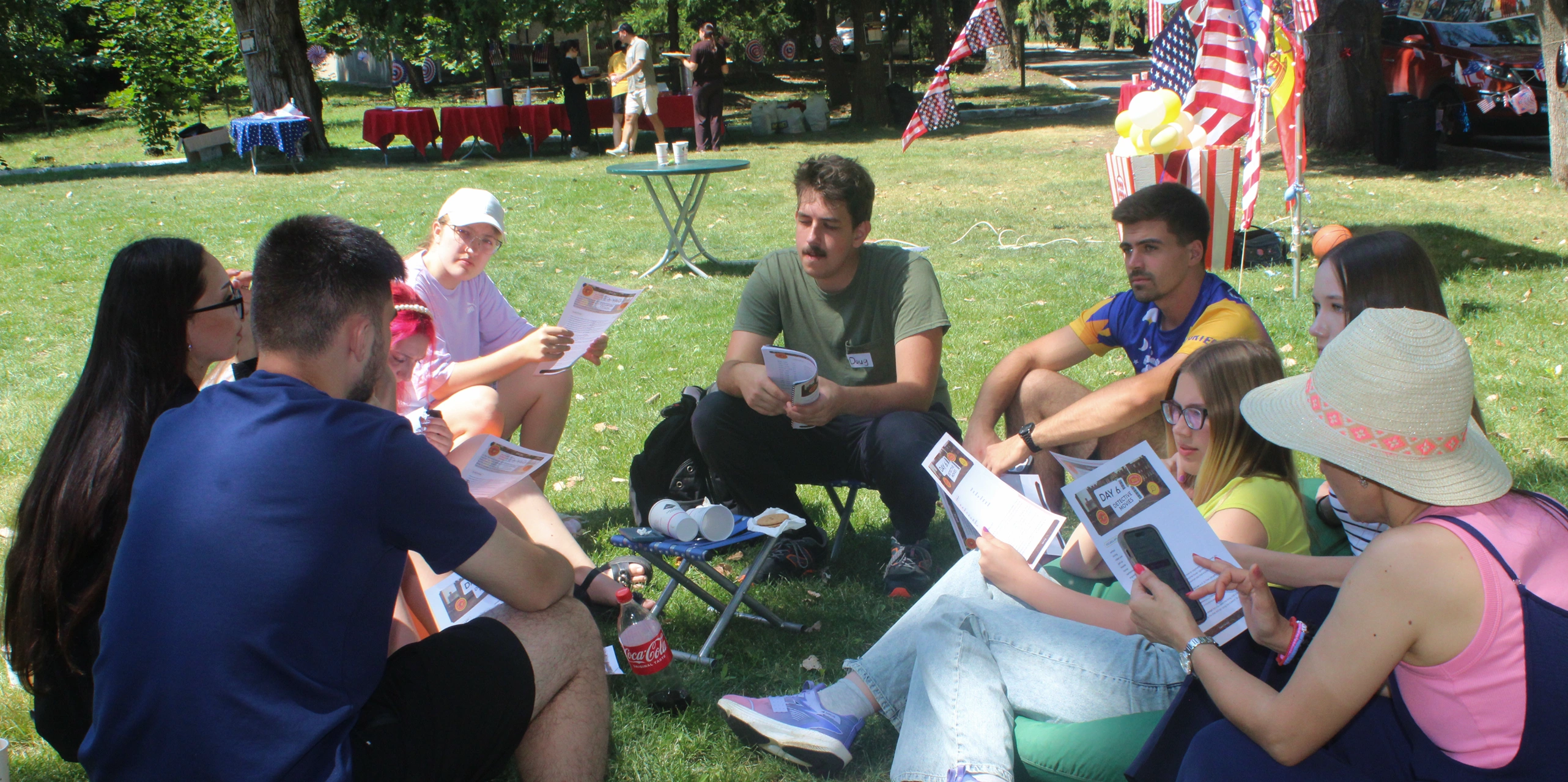 An English Club group studying together outdoors at camp