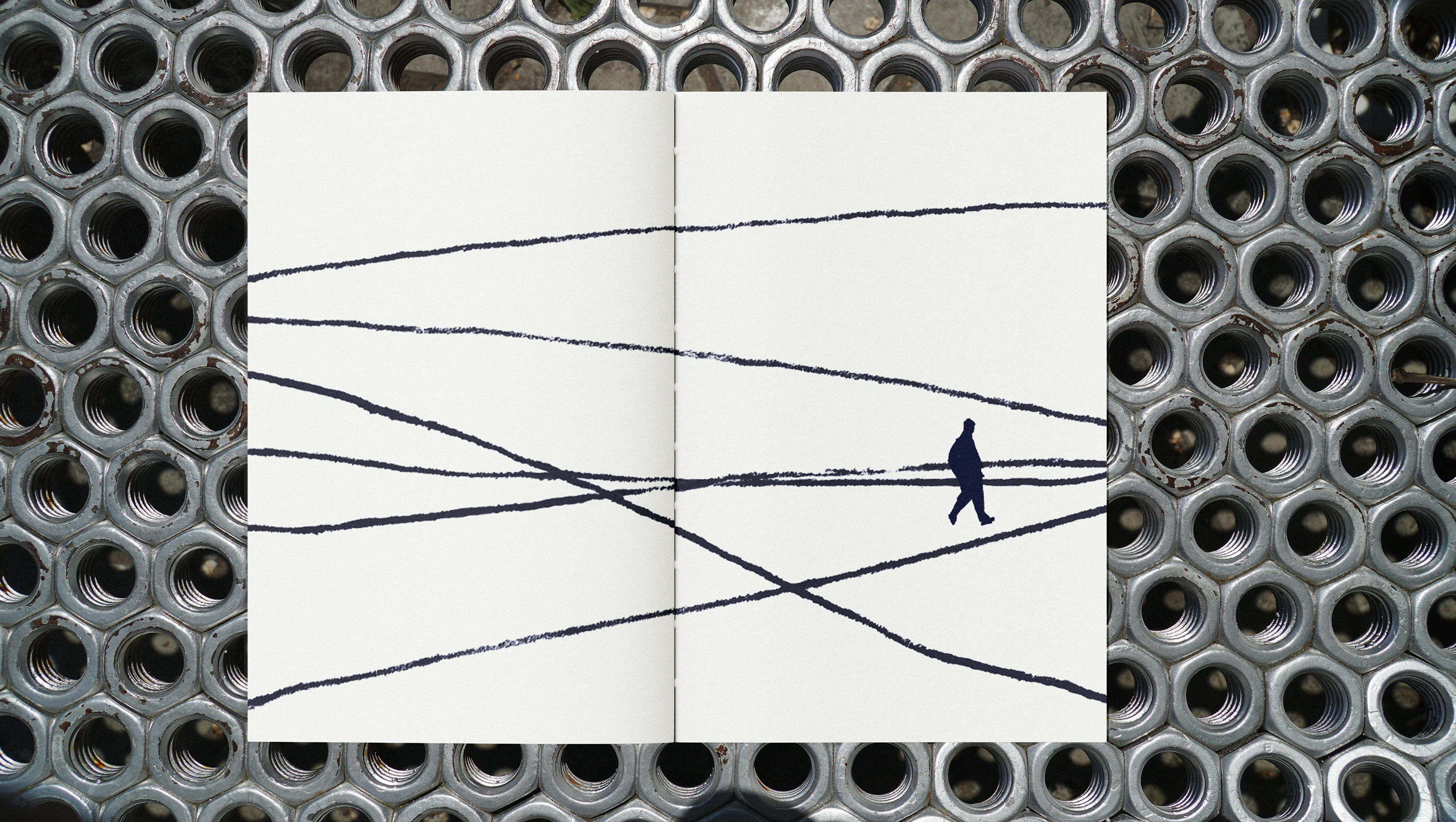 An illustrated spread showing a figure and intersecting hand-printed paths