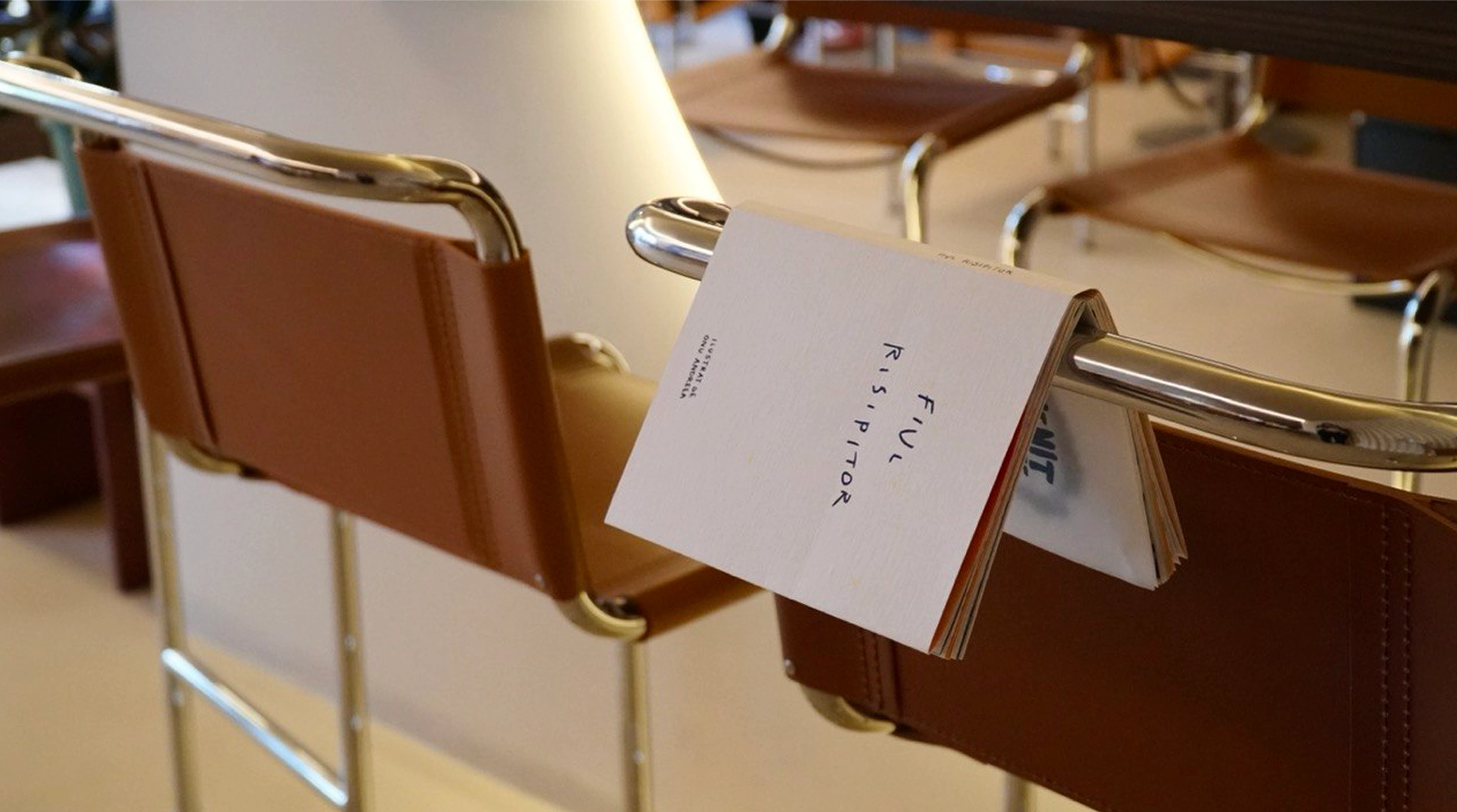 The handmade Prodigal Son book hanging over a chair