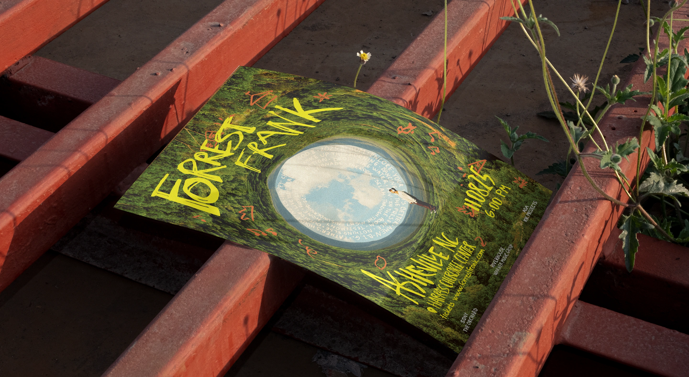 Green Asheville tour poster resting on weathered red steps