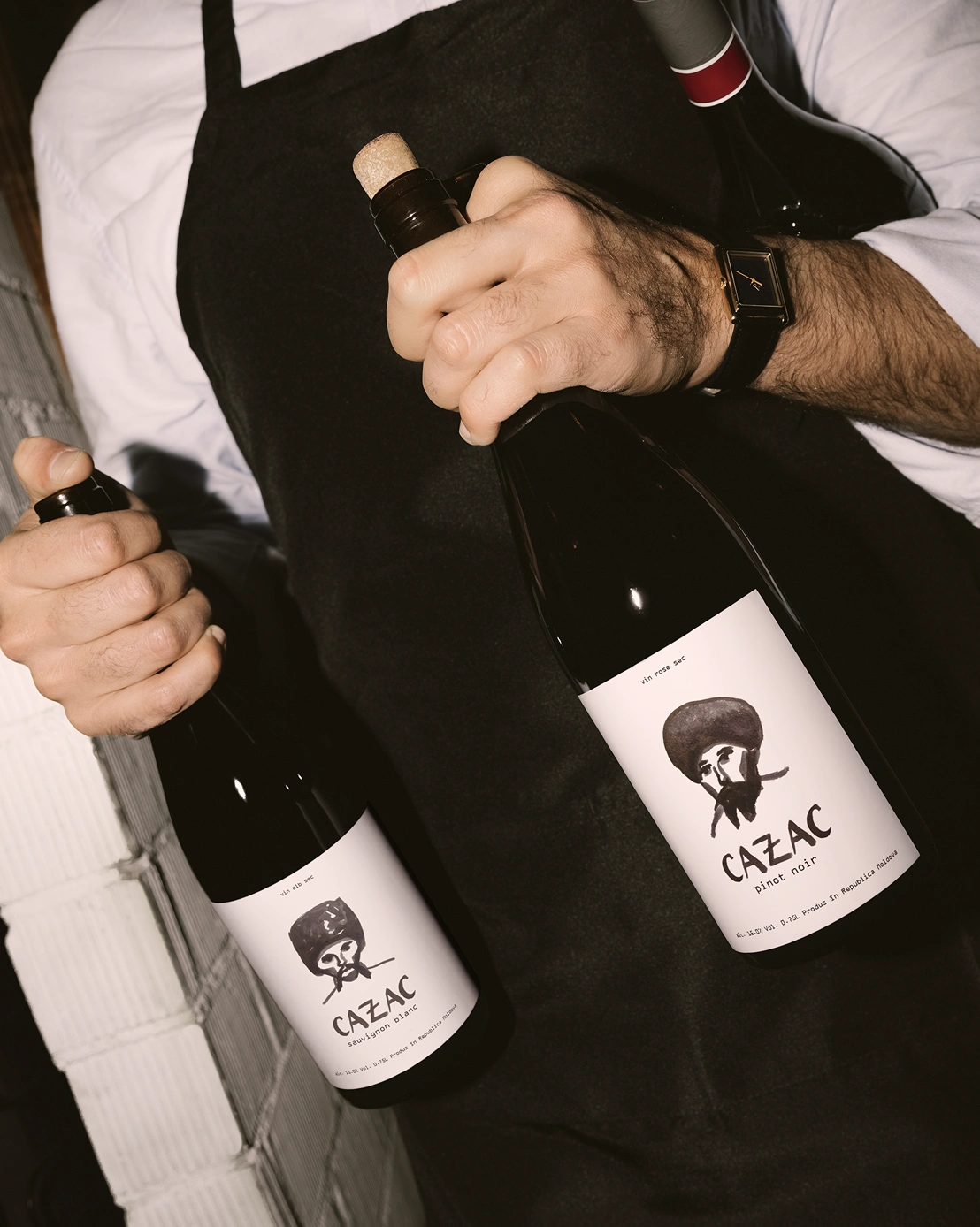 Two Cazac wine bottles with illustrated labels