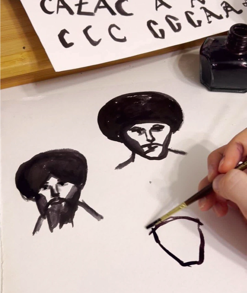 Painting the Cazac lettering and characters with ink on paper