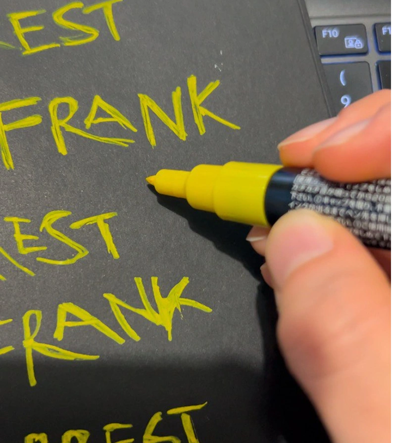 Sketching the lettering by hand with a yellow acrylic marker