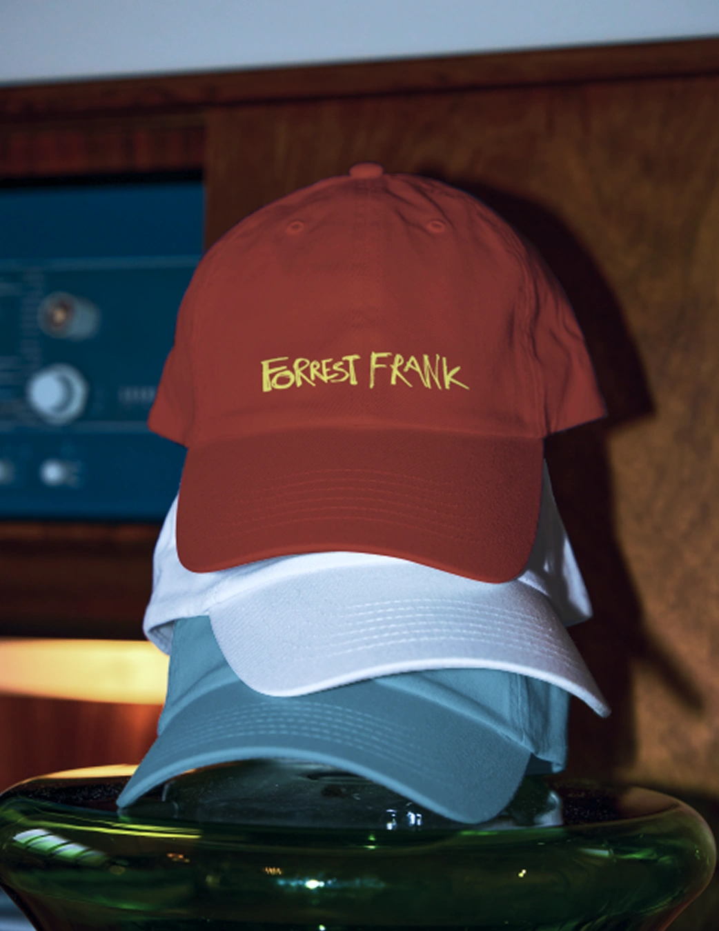Stack of red, white, and blue Forrest Frank caps