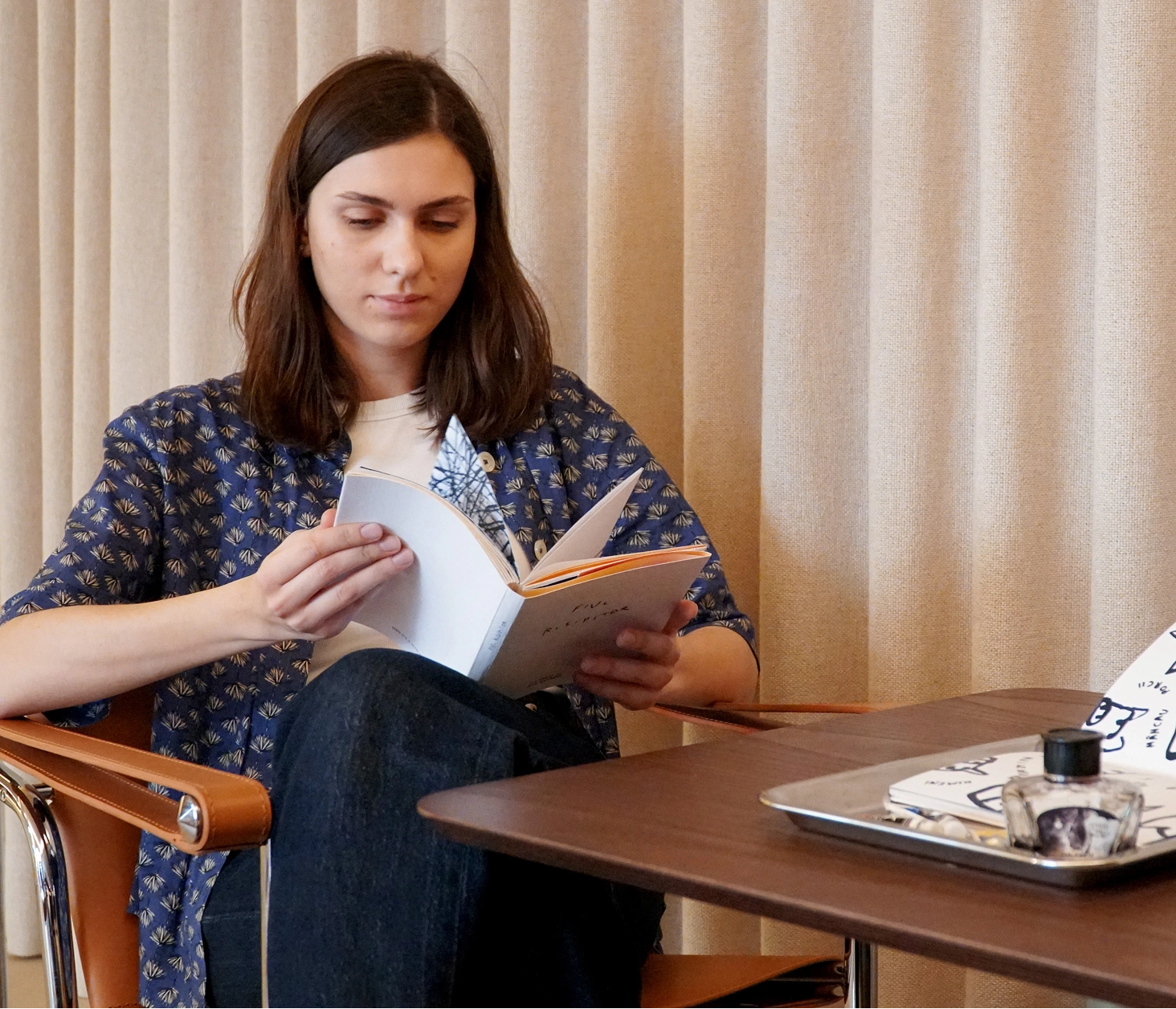 Reading the handmade book at a table