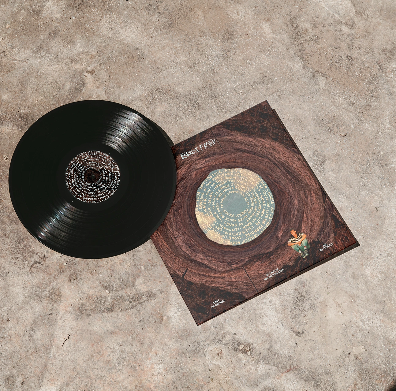 Vinyl record and Phoenix album sleeve on a stone floor
